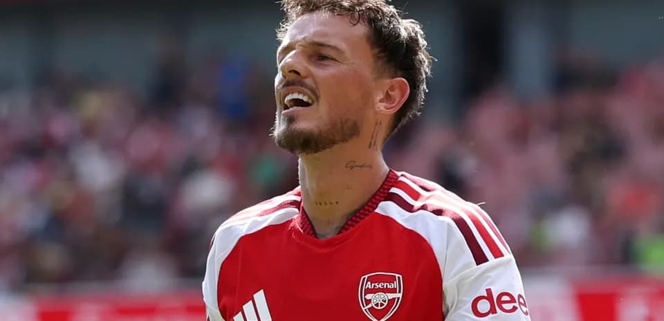 Player in Arsenal kit reacting during match