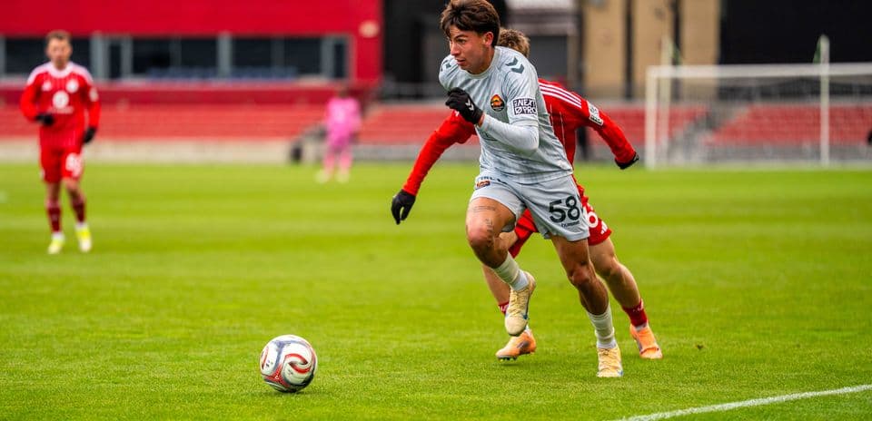 Player dribbling ball during Carolina Core match