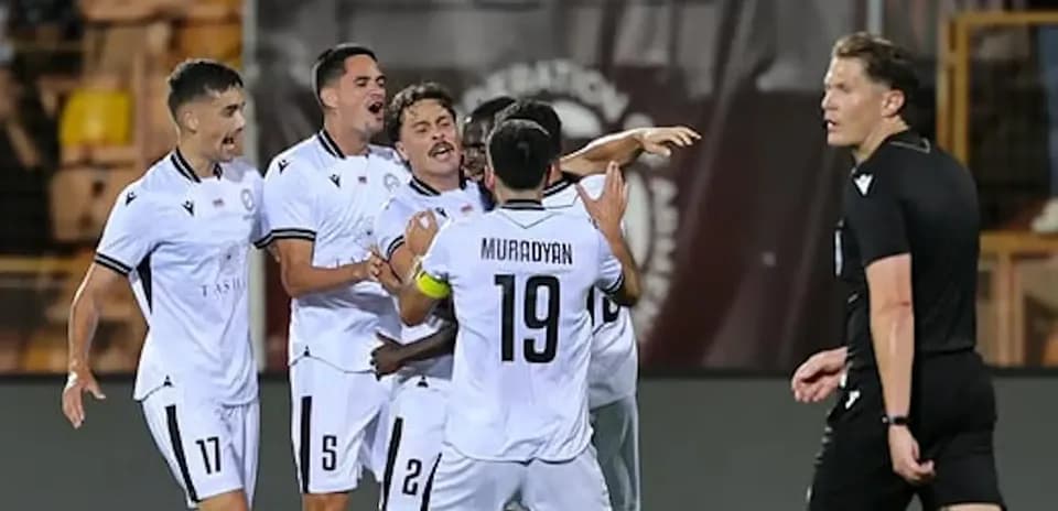 Players celebrating a goal in UEFA match