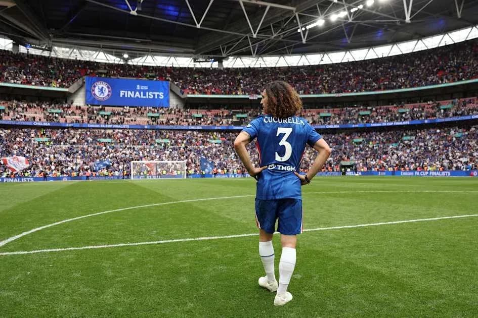 Player in Chelsea kit walking on Wembley pitch