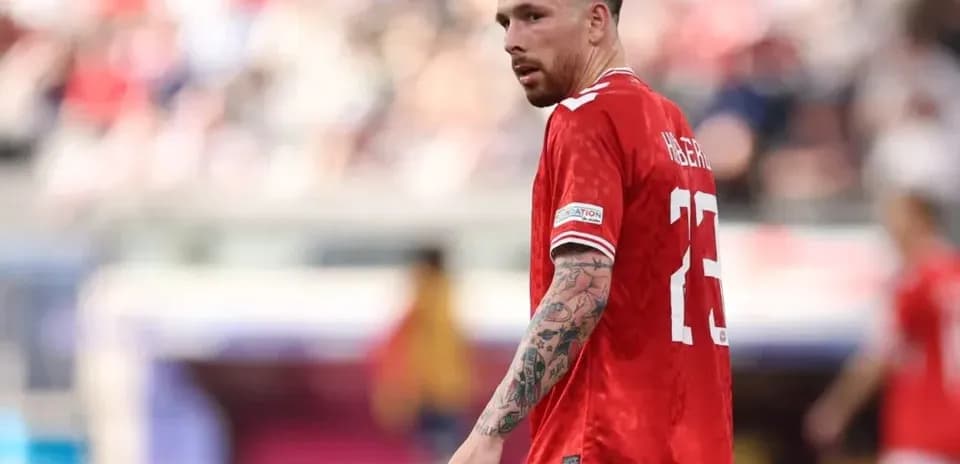 Player wearing red jersey during football match