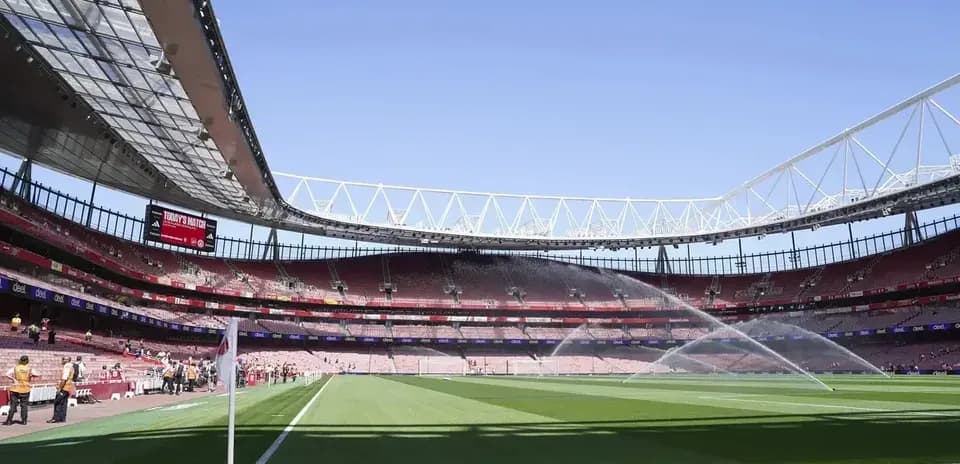 View of stadium with sprinklers on the pitch