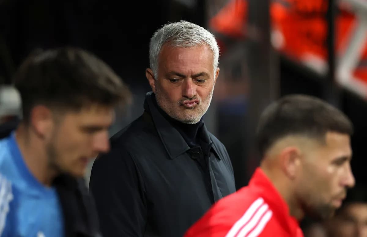 Coach observing players on the sidelines during match