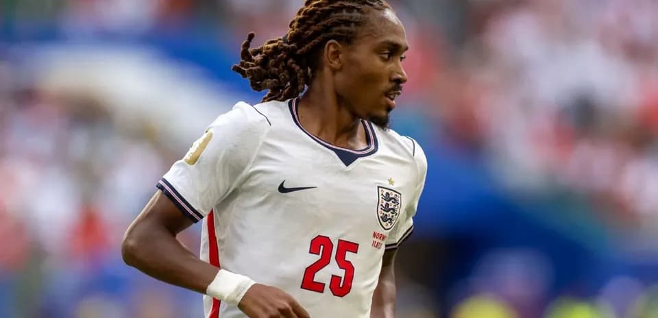 Player in England kit running on the field