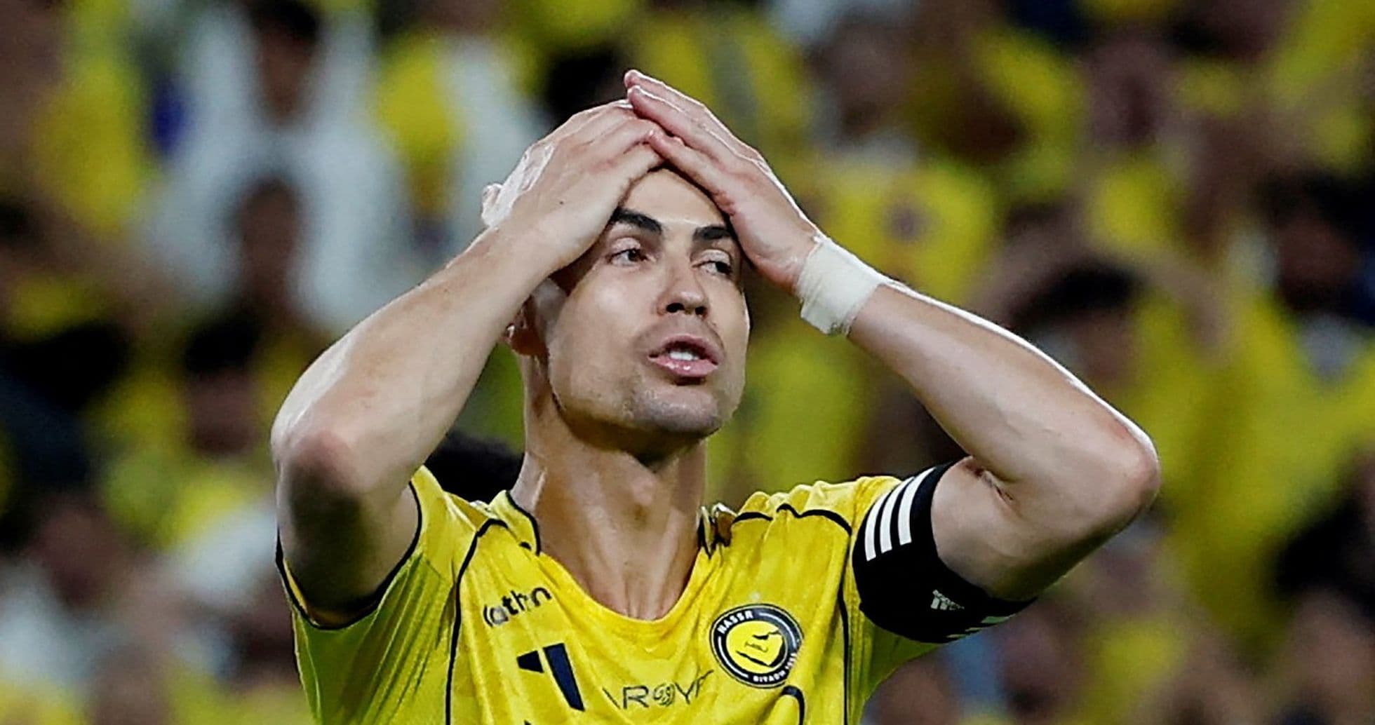 Player in yellow jersey showing frustration on field