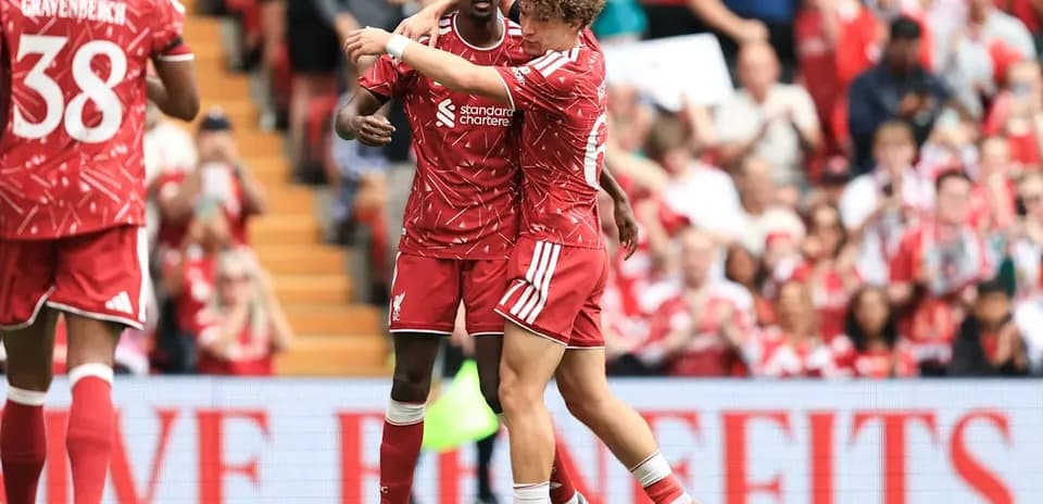 Liverpool players celebrating on the pitch together