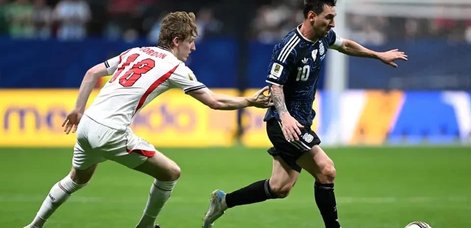 Player in blue jersey evading opponent in white jersey