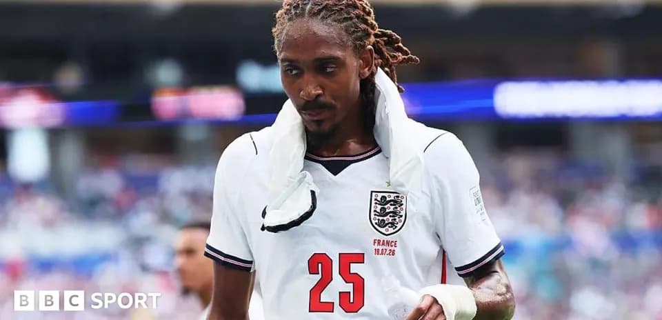 Player wearing England jersey walking off the field