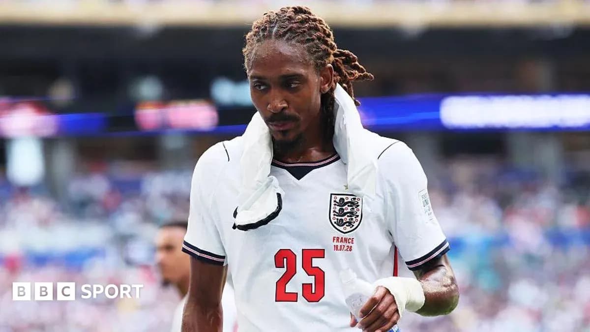 Player wearing England jersey walking off the field