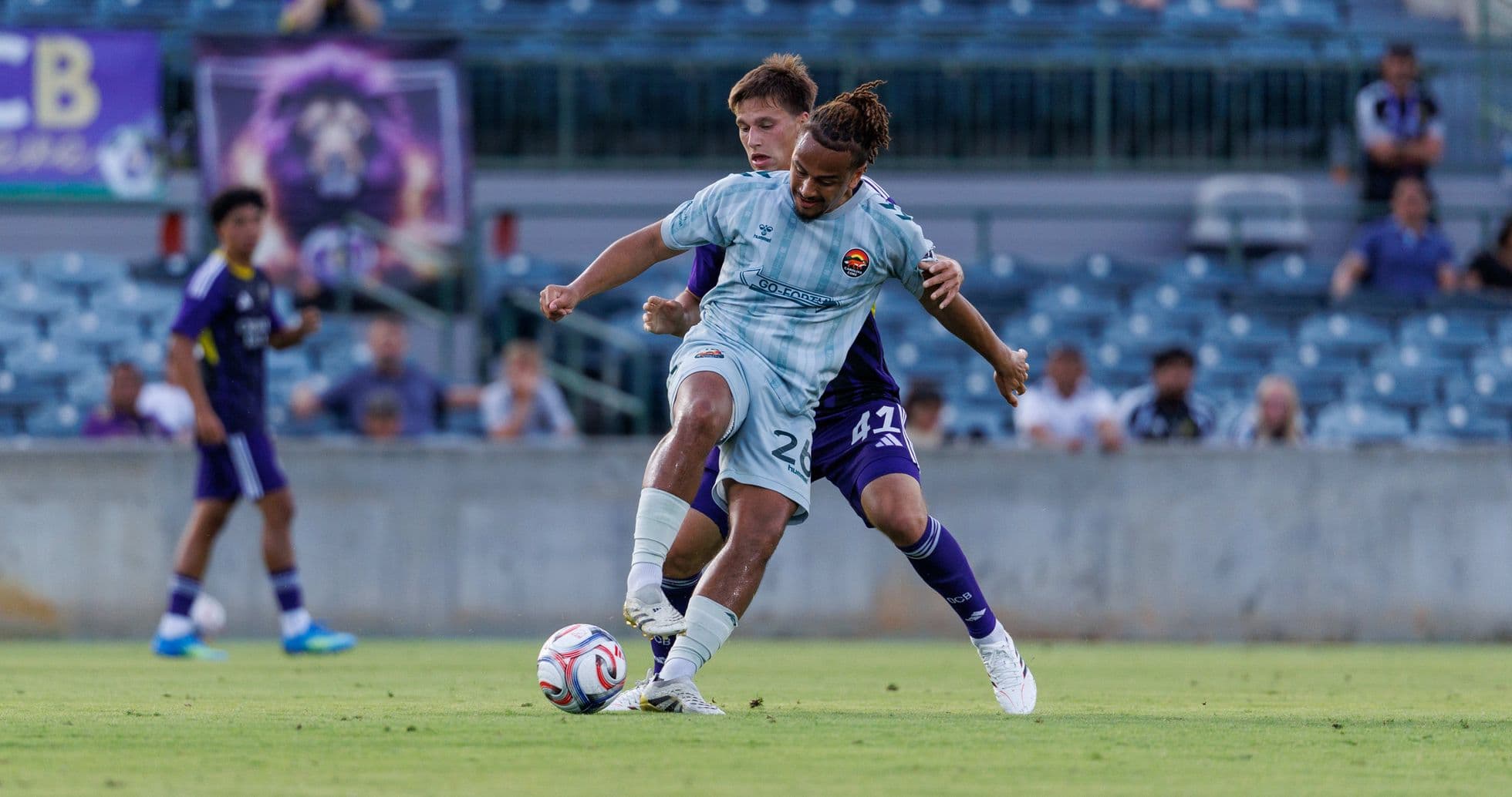 Players competing for the ball in MLS Next Pro