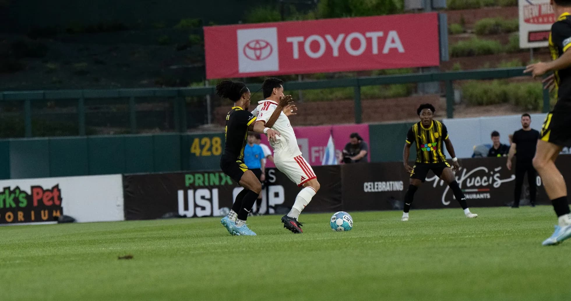Players competing for the ball in USL Cup
