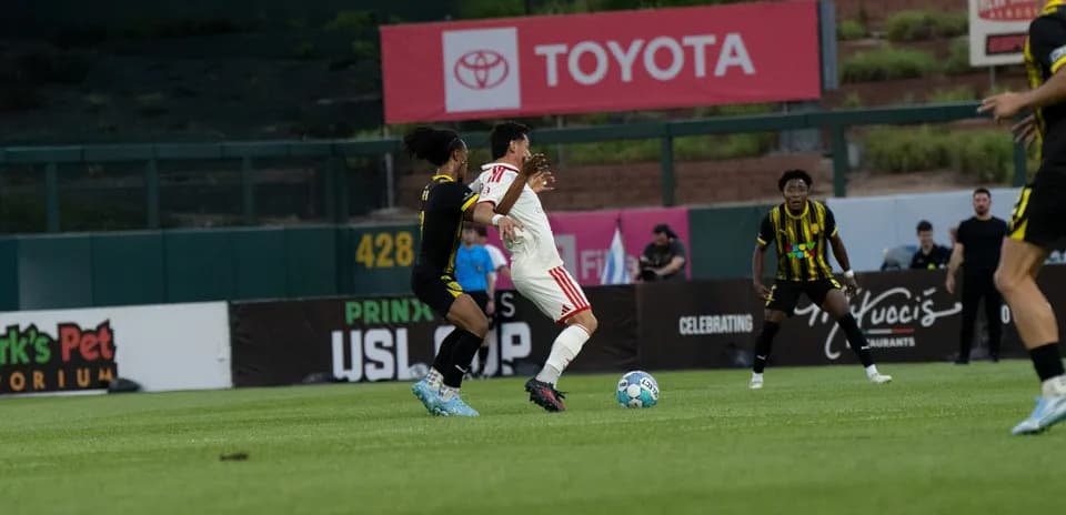 Players competing for the ball in USL Cup