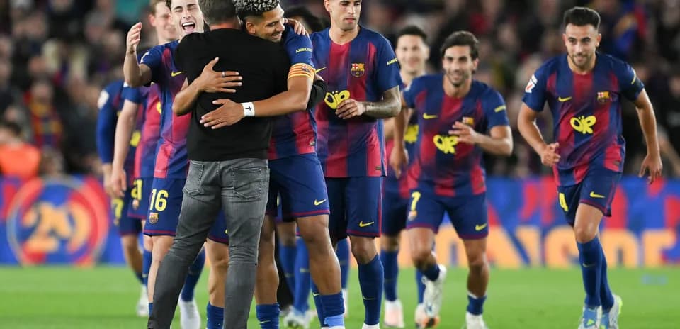 Barcelona players celebrating with coach after victory
