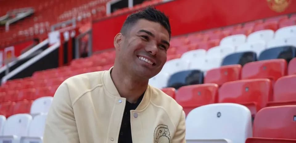 Player sitting in empty stadium seats, smiling