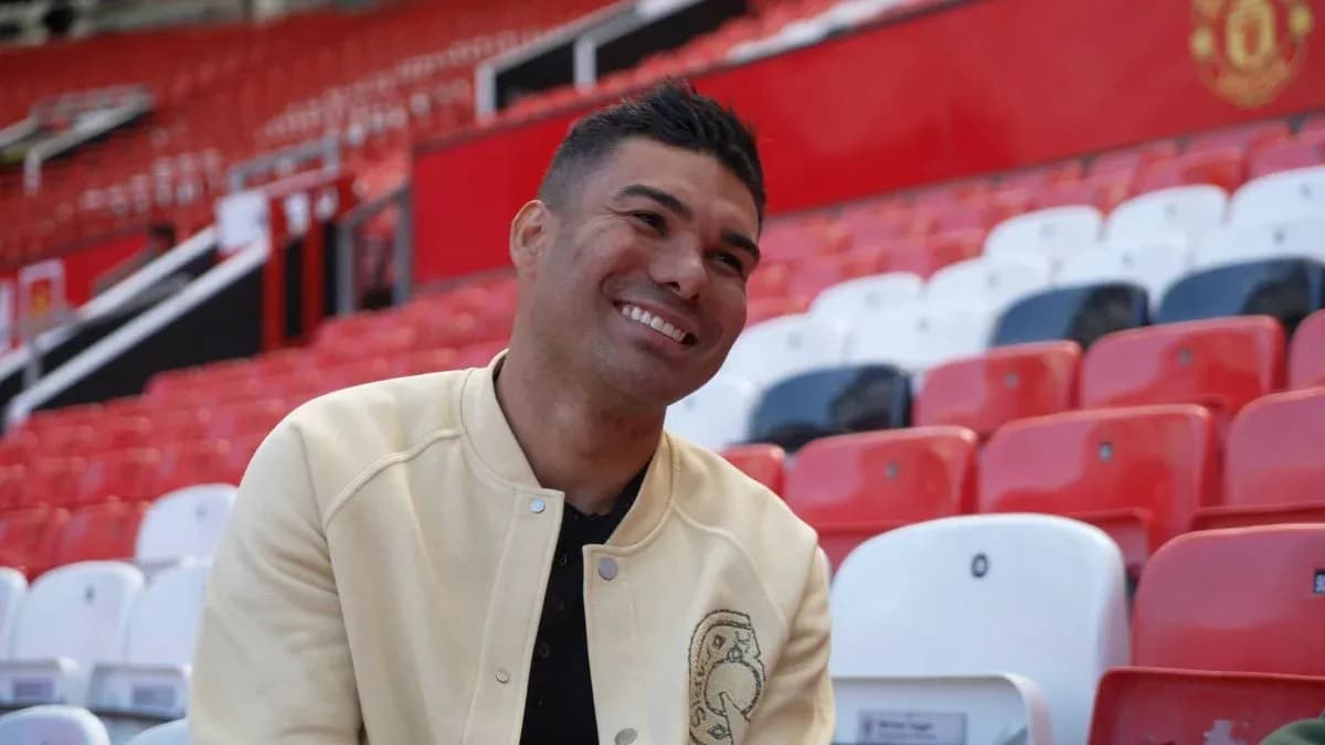 Player sitting in empty stadium seats, smiling