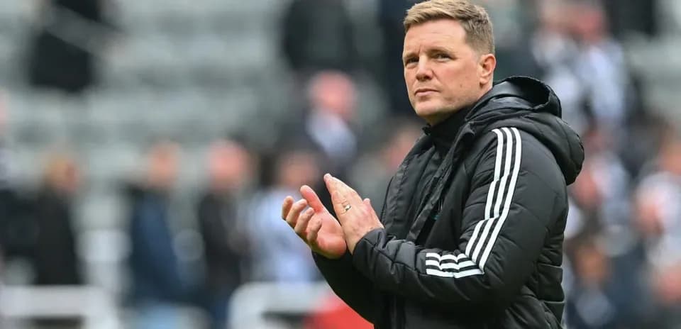Manager applauding fans during a match