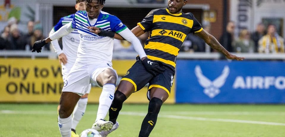 Two players contesting for the ball in match