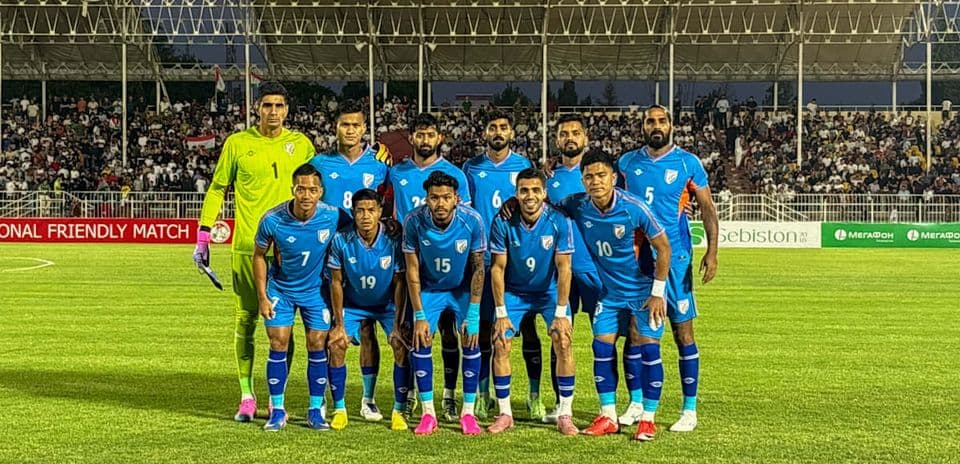 Football team posing for photo before friendly match