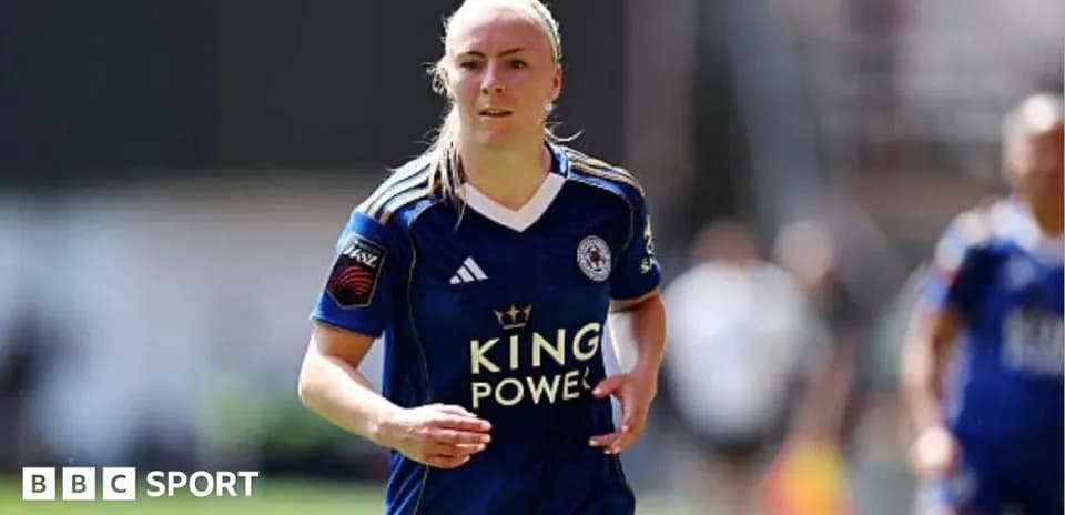 Female football player running in blue team jersey