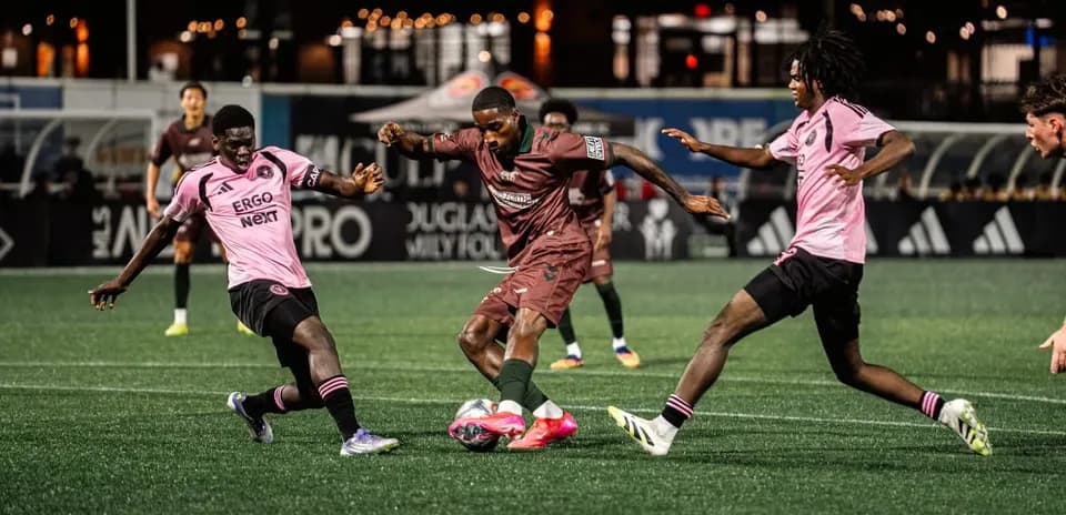 Players competing for the ball in MLS Next Pro