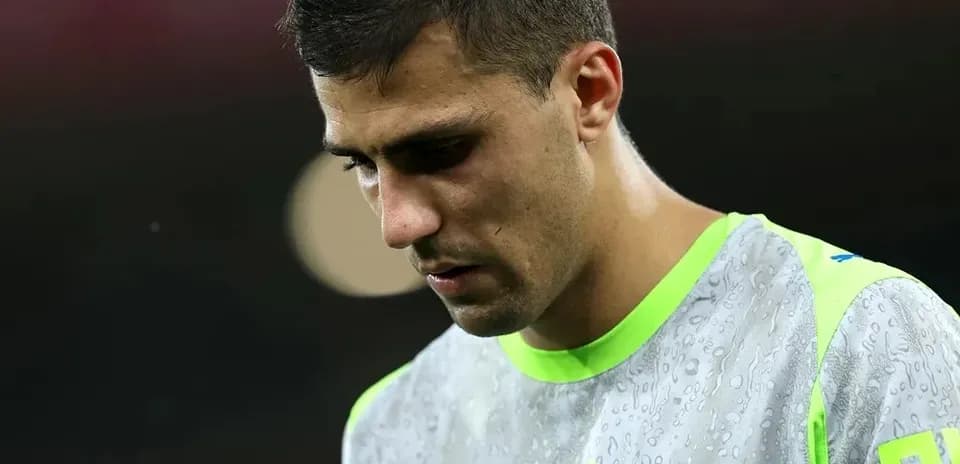Goalkeeper in training gear looking down