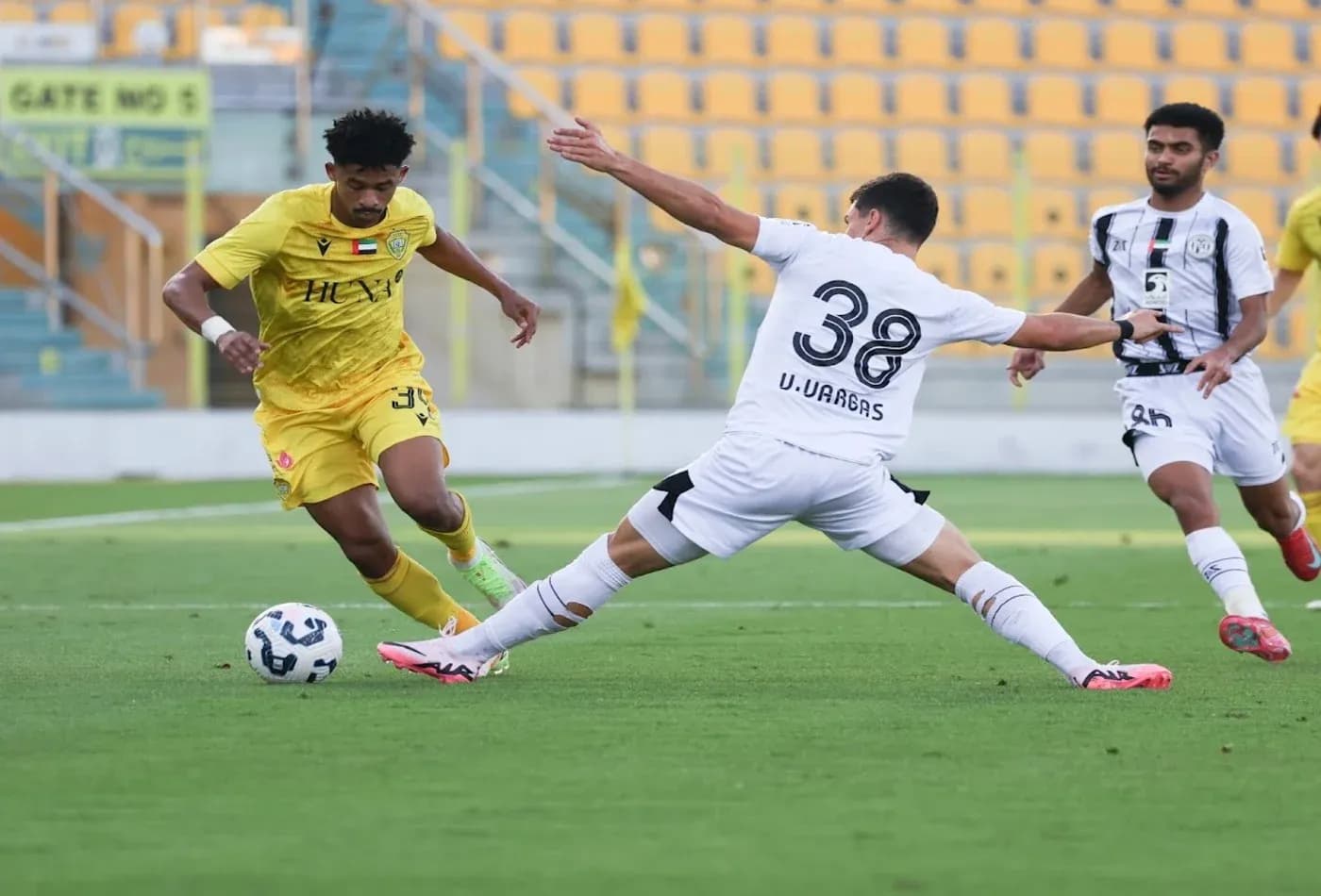 Al Wasl U23 player dribbling past Al Jazira U23