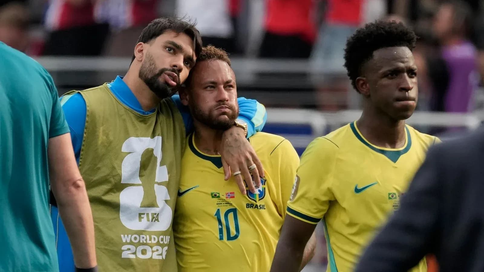 Brazilian players on the sidelines after match