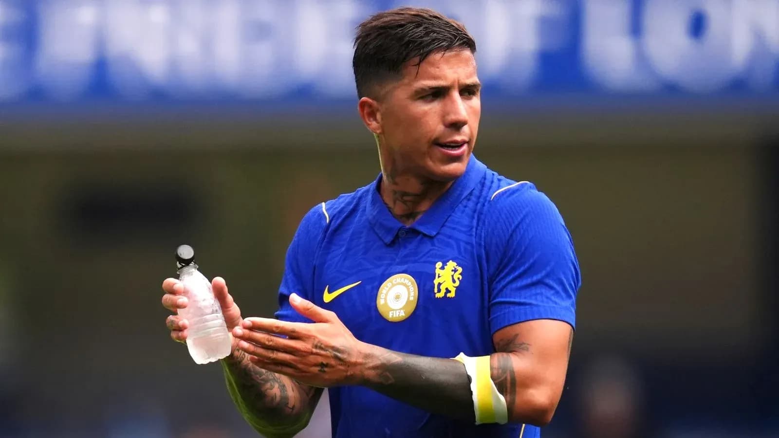 Player holding water bottle during match warm-up