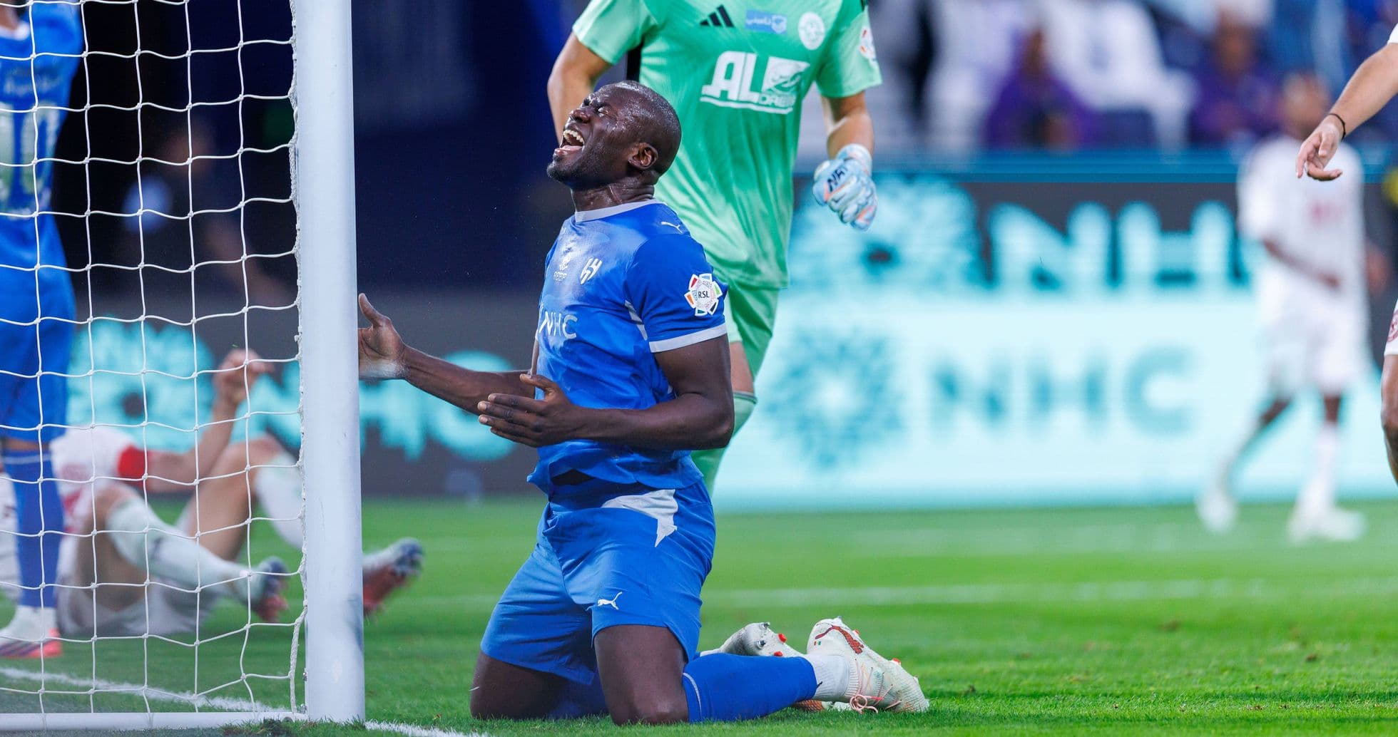 Player on knees near goalpost after missing shot