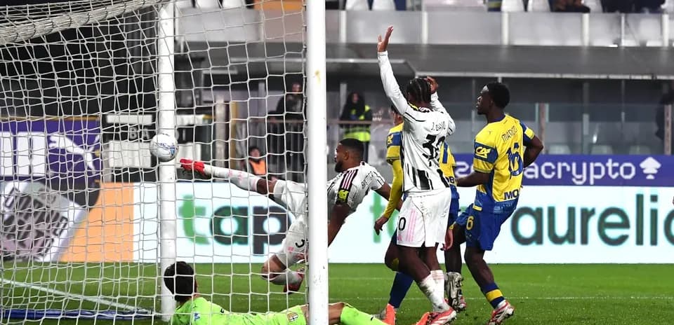 Goalkeeper attempting to save a shot during match