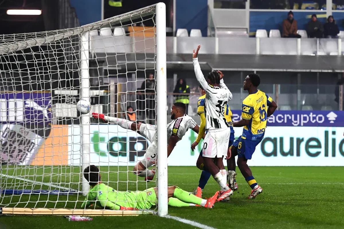 Goalkeeper attempting to save a shot during match