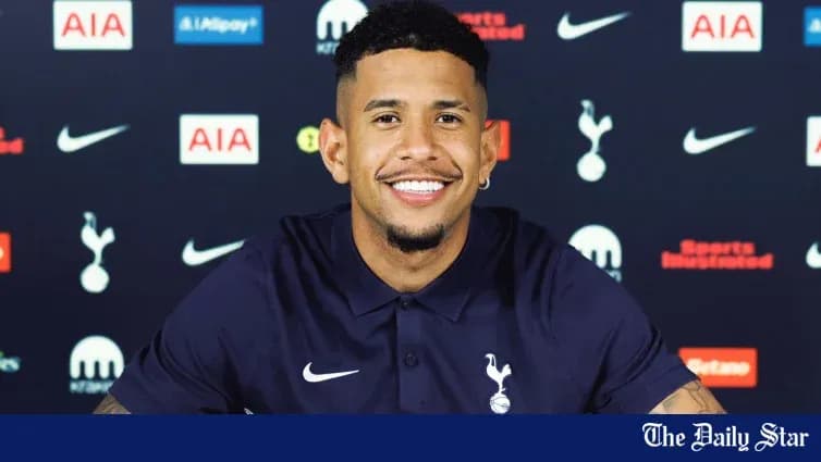 New player at Tottenham Hotspur press conference smiling