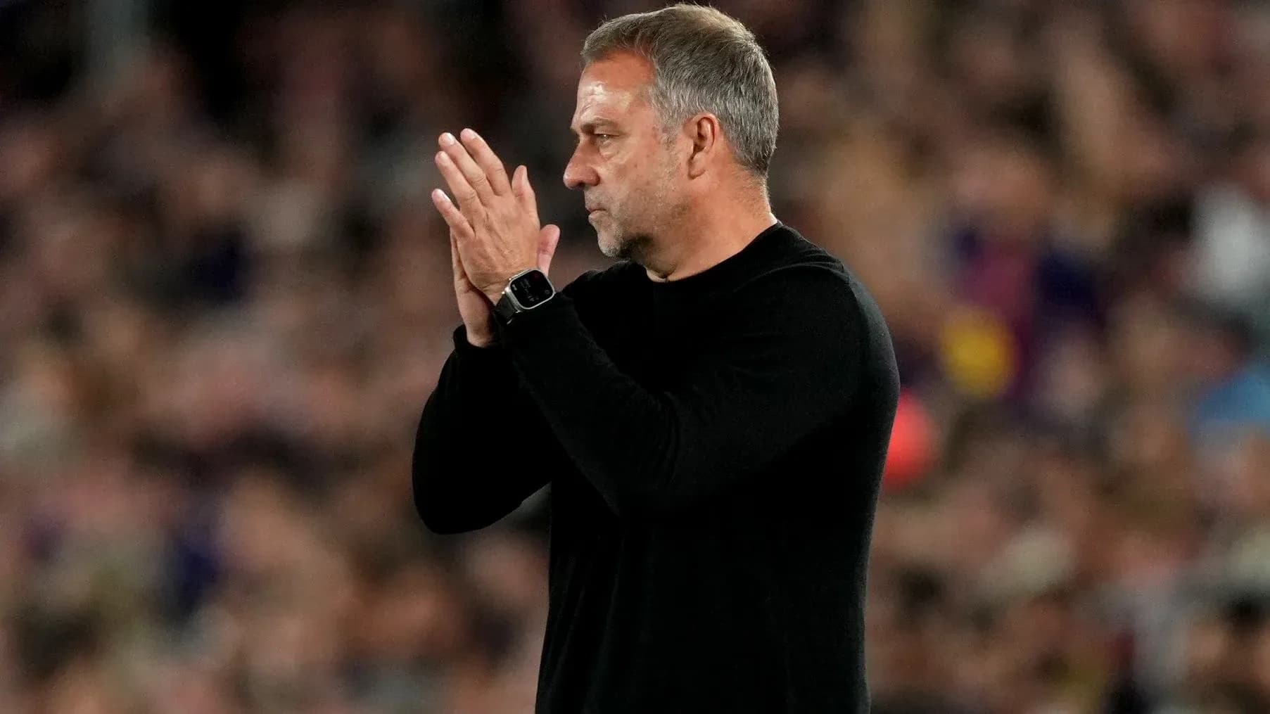 Coach clapping on the sidelines during a match