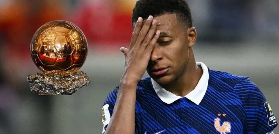 Player reacting next to a Ballon d'Or trophy