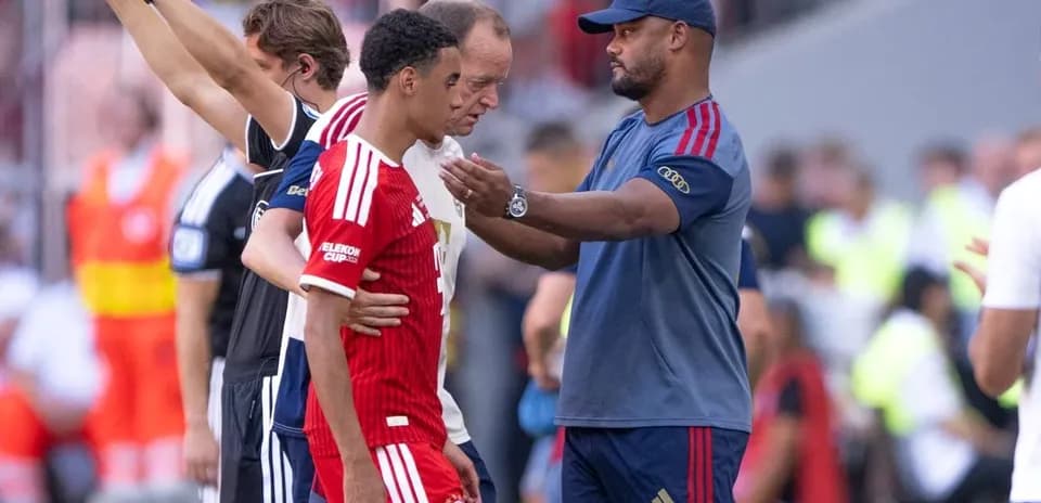Coach discussing with player during match substitution