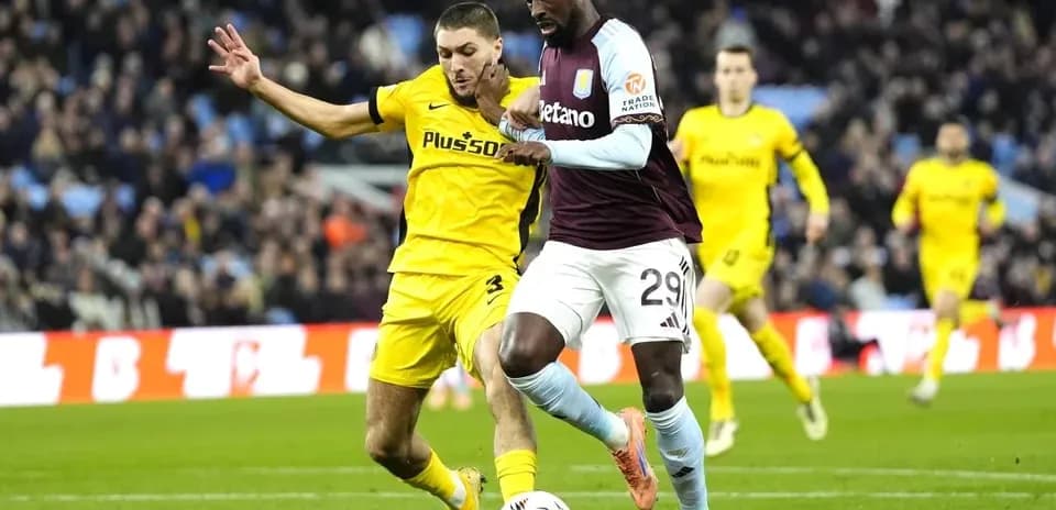 Player dribbling the ball with opponent challenging