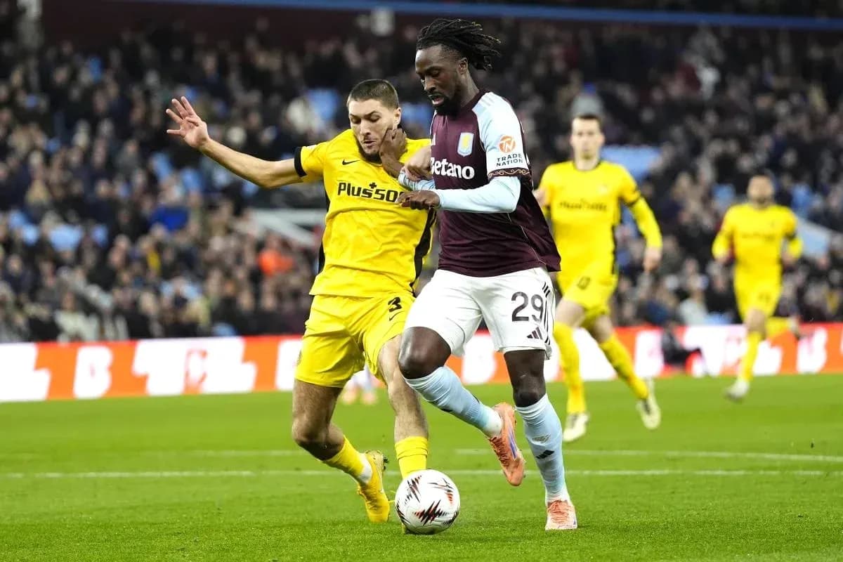 Player dribbling the ball with opponent challenging