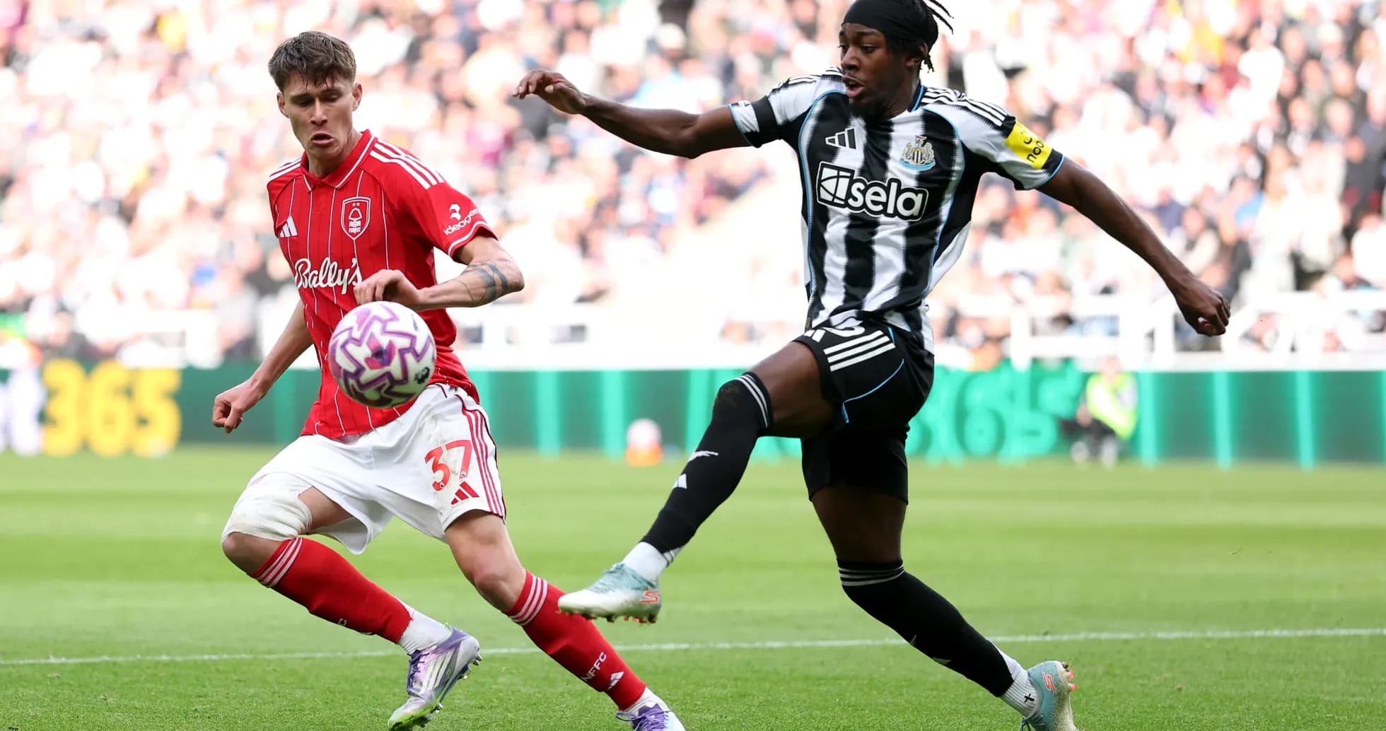 Player from Nottingham Forest challenging Newcastle player