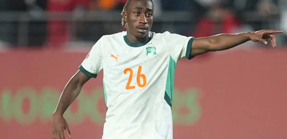 Ivorian player gesturing during a football match