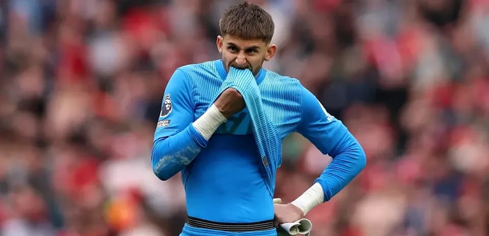 Goalkeeper holding jersey during match in stadium