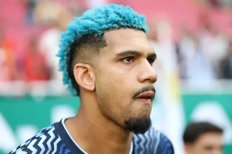 Player with blue hair during pre-match warm-up
