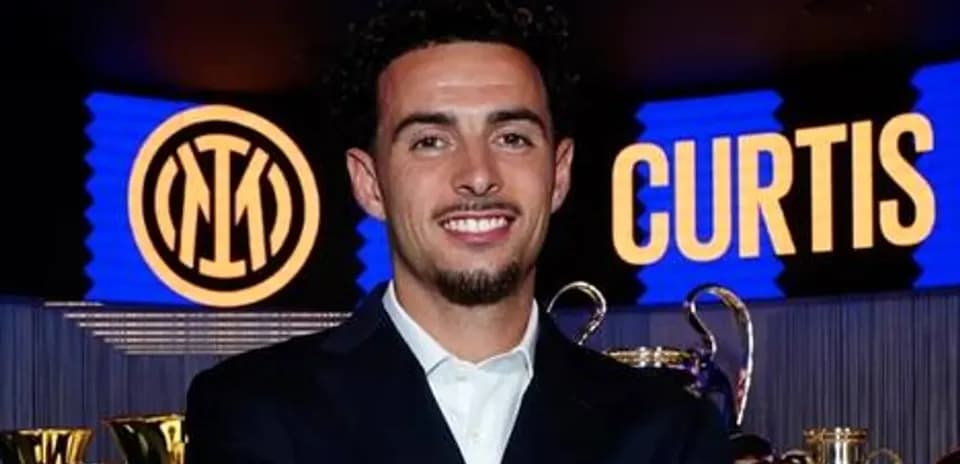Player posing with trophies at press event