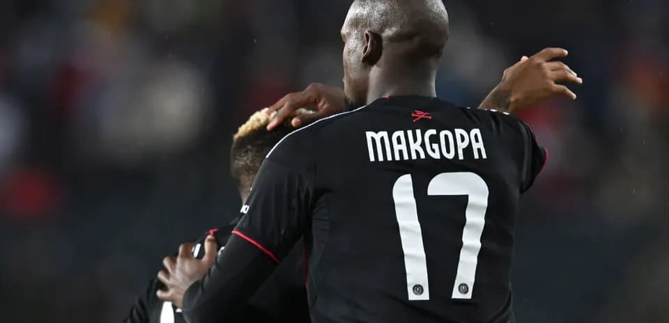 Player celebrating with teammate on the field