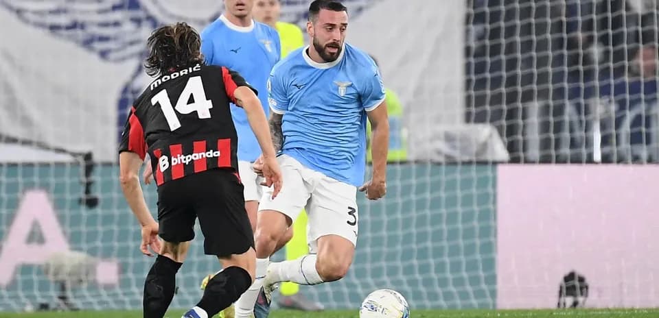 Lazio player dribbling past AC Milan opponent