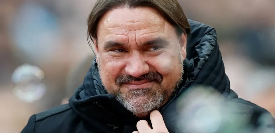 Coach in black jacket at a match