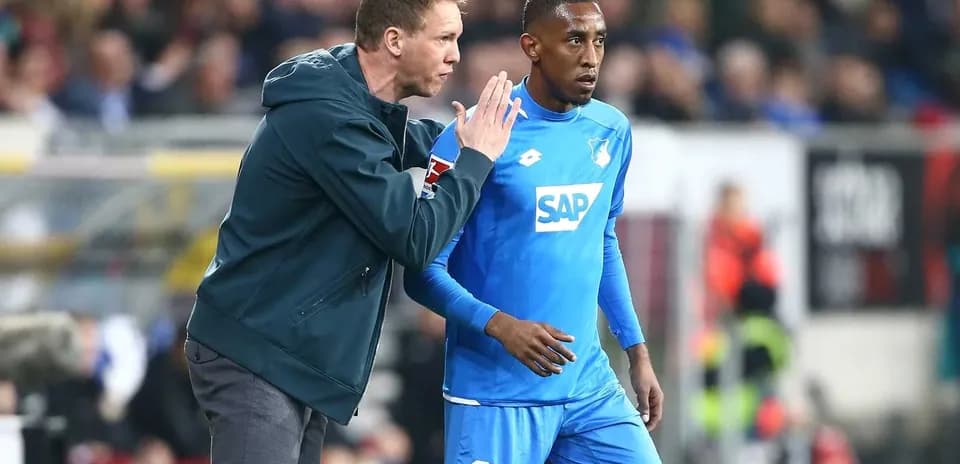 Coach giving instructions to player on sideline