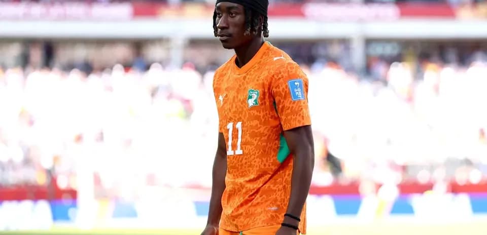 Player in orange jersey during match warm-up