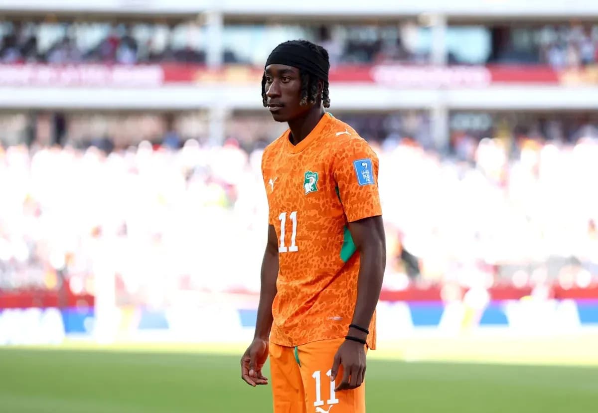 Player in orange jersey during match warm-up