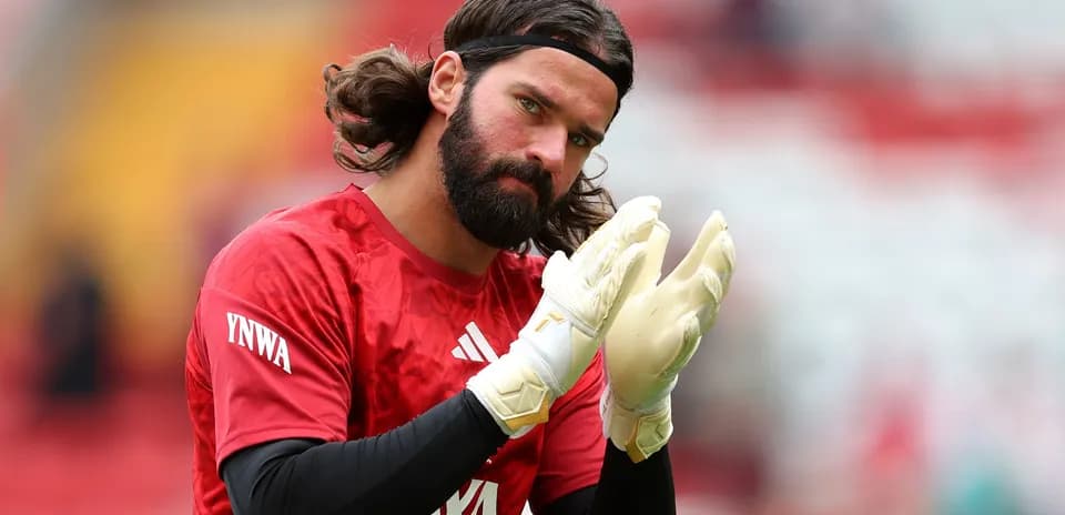 Goalkeeper warming up in red jersey and gloves