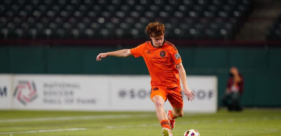 Player kicking the ball during MLS Next Pro match